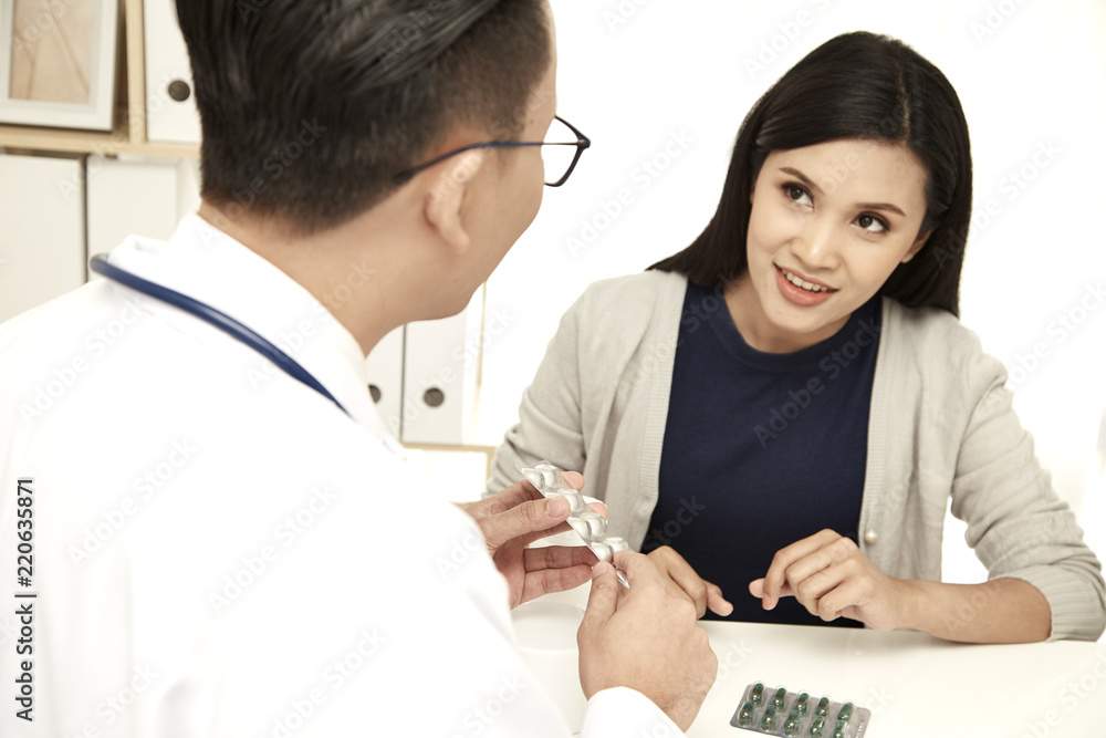 Fototapeta premium young mother is talking to a doctor