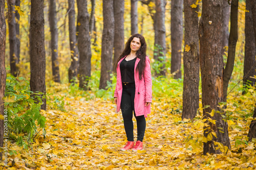 People, season and fashion concept - woman at autumn outdoors walking in park People, season and fashion concept - woman at autumn outdoors walking in park