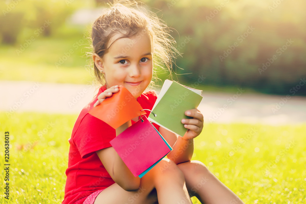 Beautiful little girl chooses a color of paint on color palette Beautiful little girl chooses a color of paint on color palette
