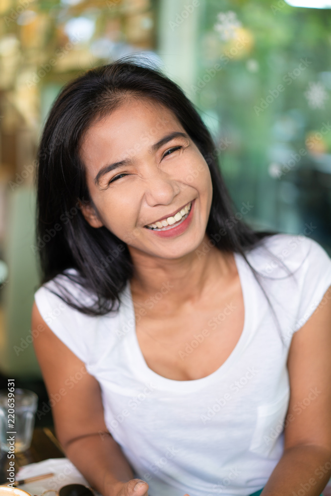 Happy middle-aged asian woman smiling, positive attitude people concept