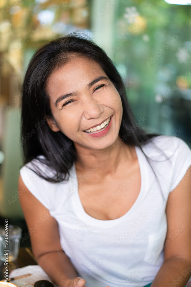Happy middle-aged asian woman smiling, positive attitude people concept Happy middle-aged asian woman smiling, positive attitude people concept