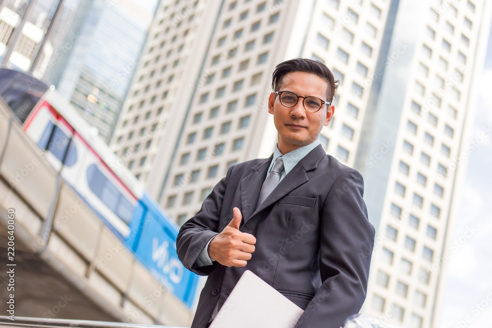 business and office concept . Young Asia handsome buisnessman showing thumbs up. business and office concept . Young Asia handsome buisnessman showing thumbs up.