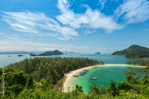 White sand beach and Long-tail boat at Kham-Tok Island (koh-kam-tok), The beautiful sea Ranong Province, Thailand.