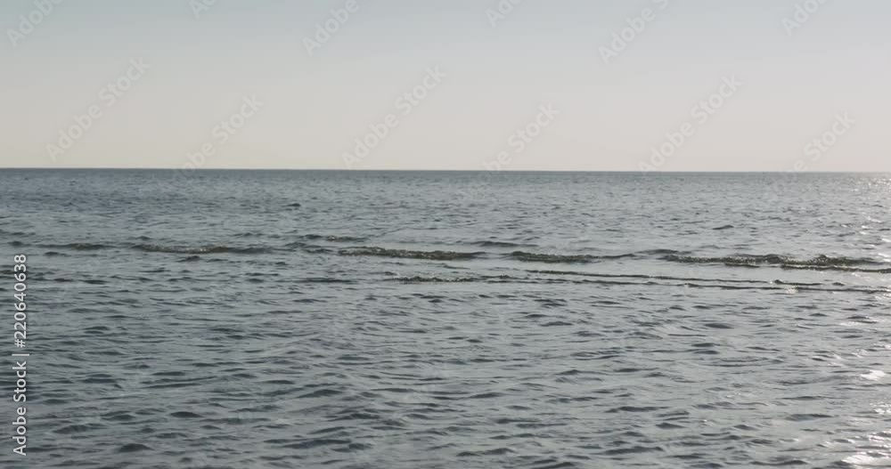 waves on a beach on a windy sunny day waves on a beach on a windy sunny day