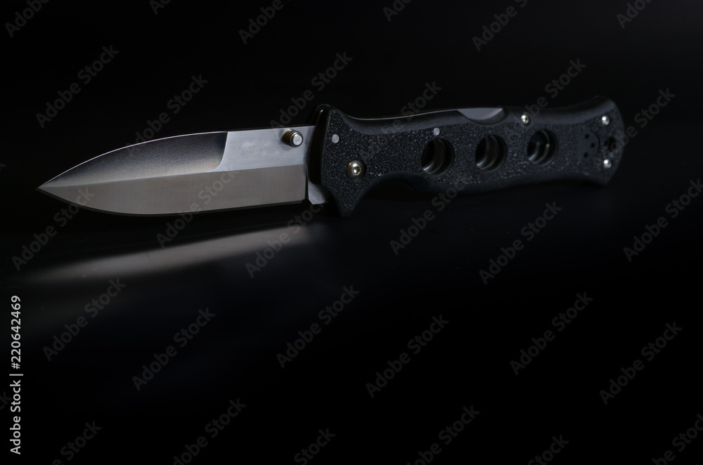 Urban knife. Black knife on black background. Urban knife. Black knife on black background.