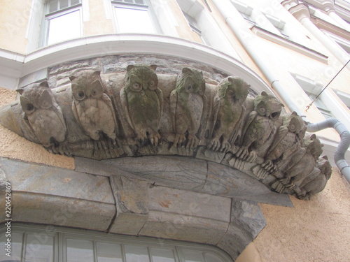 An interesting architectural detail, decorating the building - figures of the owls photo