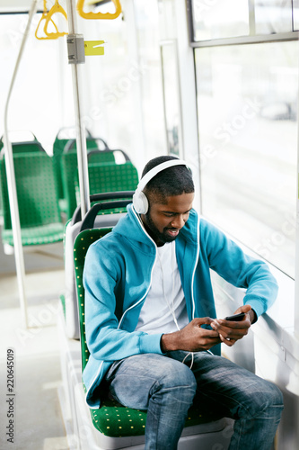 Man Riding In Bus Listening Music In Headphones