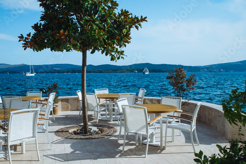 cafe with beautiful view at blue sea water. mountains on background