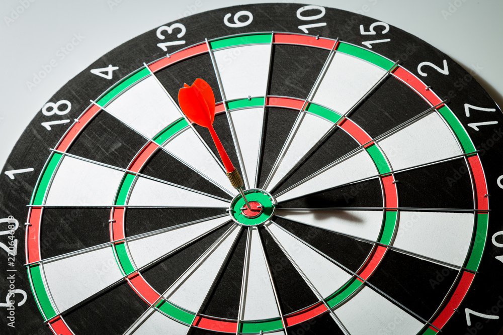 dart arrow hitting in the target center of dartboard. concept of the success dart arrow hitting in the target center of dartboard. concept of the success