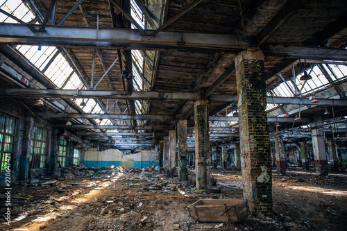 Abandoned ruined industrial warehouse or factory building inside, corridor view with perspective, ruins and demolition concept