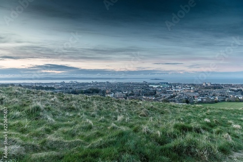 Sunset colours and top view of Edinburgh city from Arthur's Seat in Holyrood Park photo