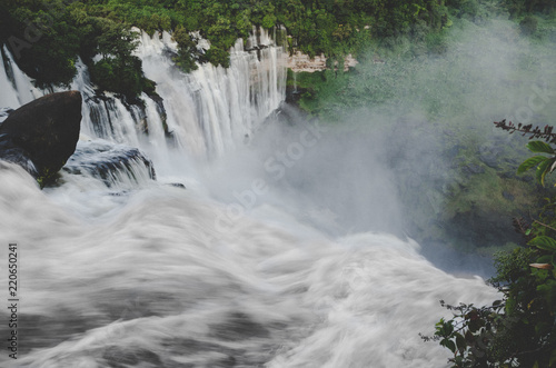 Kalandula waterfalls of Angola in full flow with lush green rain forest, rocks and spray, Africa