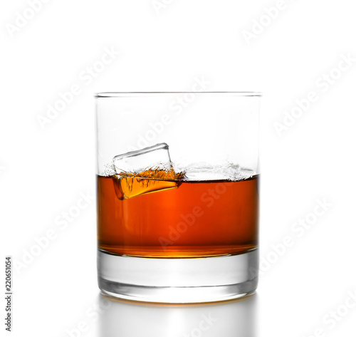 Whisky glass with splashes, isolated on white