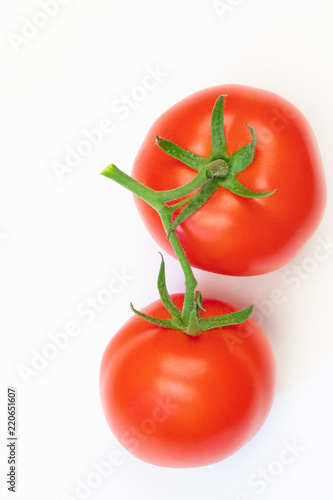 red tomatoes on a green branch