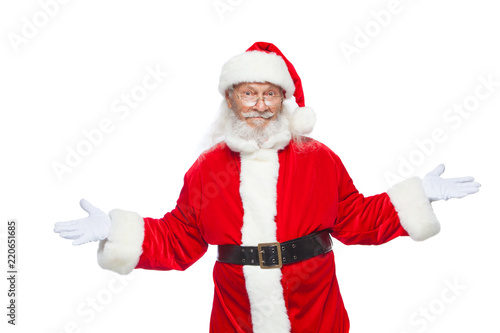 Christmas. Sales, marketing, discount, advertising, gifts. Santa Claus gestures with his hands as if he is holding something and has to choose between two options. Isolated on white background.