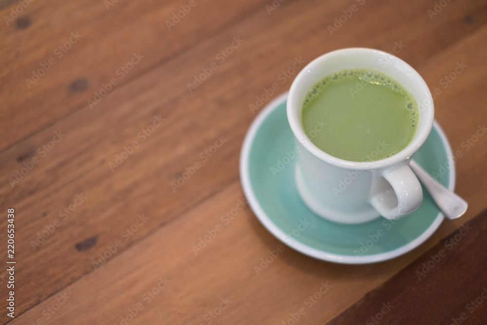 hot matcha green tea on wooden table hot matcha green tea on wooden table