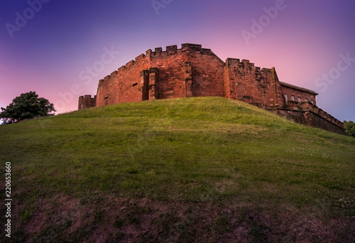 Chester medieval Castle at sunset, beyond the city wall. The castle and the walls are one of the major tourist attraction of the City of Chester.