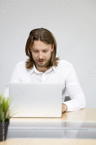 Young man working on laptop...