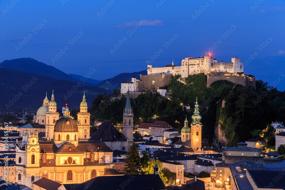 Salzburg Cathedral and famous Festung Hohensalzburg illuminated in  twilight