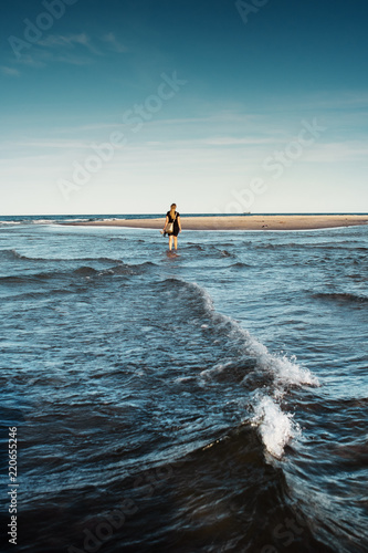 Photos Girl standing on the beach where Baltic Sea and North Sea meets