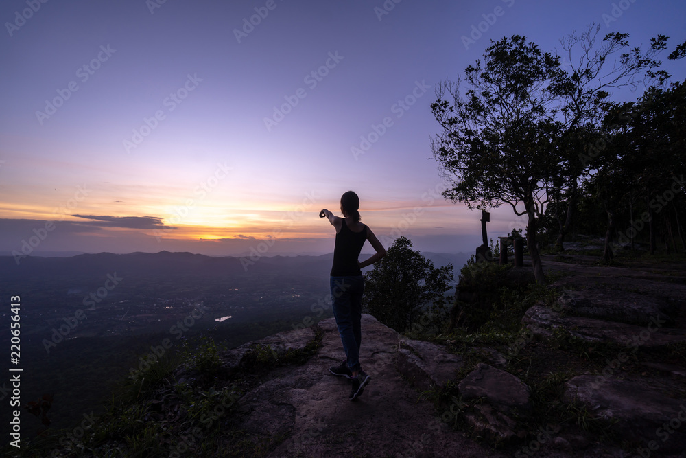 Woman successful hiking climbing silhouette in mountains