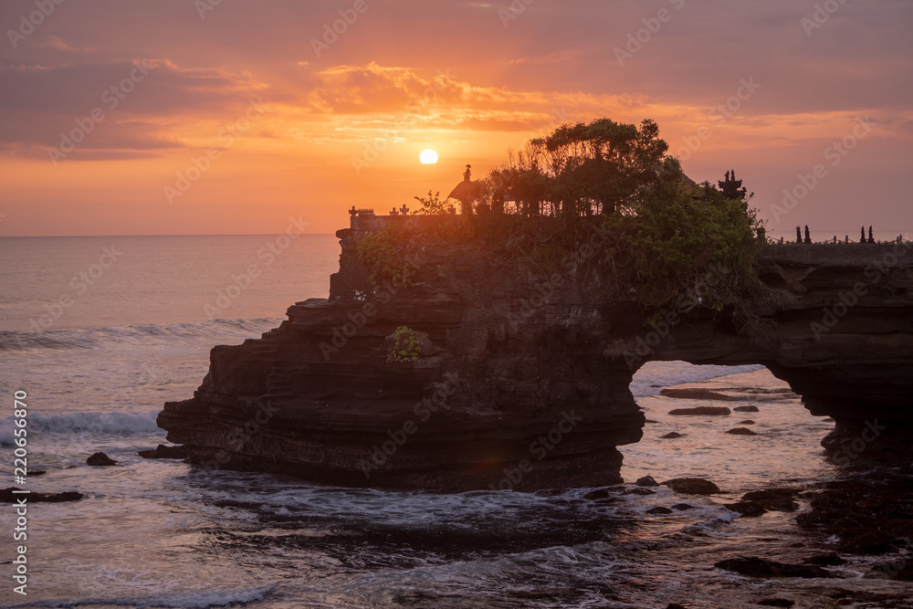 Sunset at Pura Batu Bolong temple on the beatiful rock in Bali