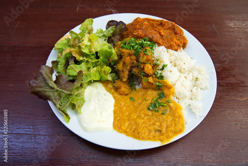 Homemade chicken tikka, indian cuisine, serve with vegetable lay on polish wood table.