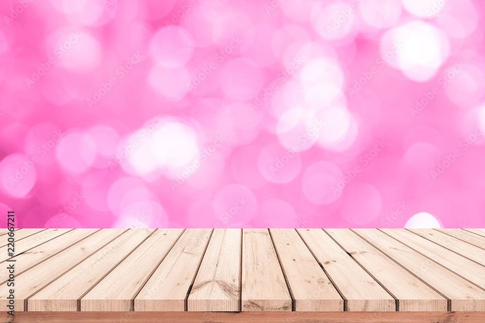 Wood plank with abstract pink blurred bokeh background for product display Wood plank with abstract pink blurred bokeh background for product display