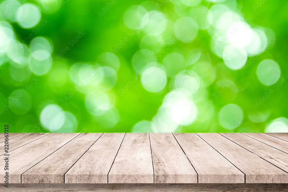 Wood plank with abstract green blurred bokeh background for product display Wood plank with abstract green blurred bokeh background for product display