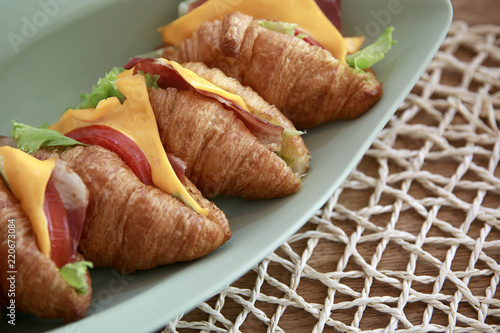 Delicious croissant sandwich on table, closeup