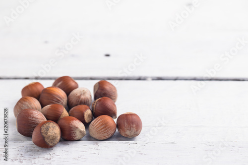 Hazelnuts on white ristic wooden desk. Christmas mood. Space for text. photo