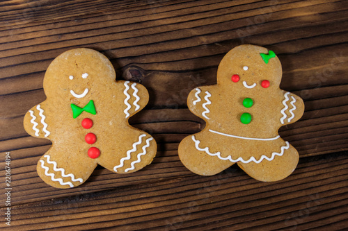 Christmas gingerbread couple cookies on wooden table. Top view