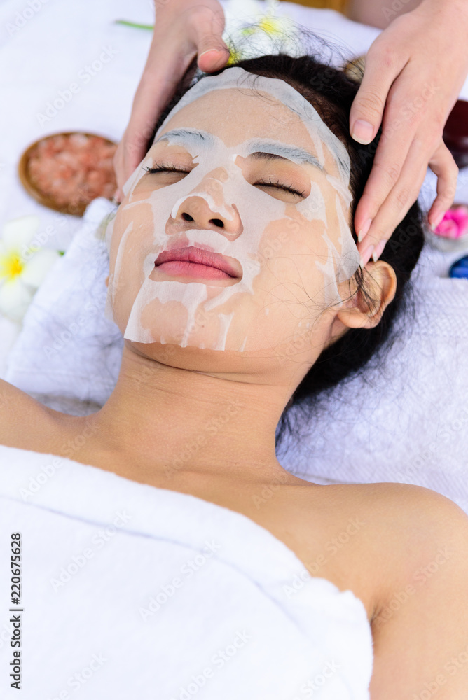 Portrait of beautiful asian people has masking with close up view and close up eyes and having hand massage in spa salon. Beauty, healthy, spa and relaxation concept.