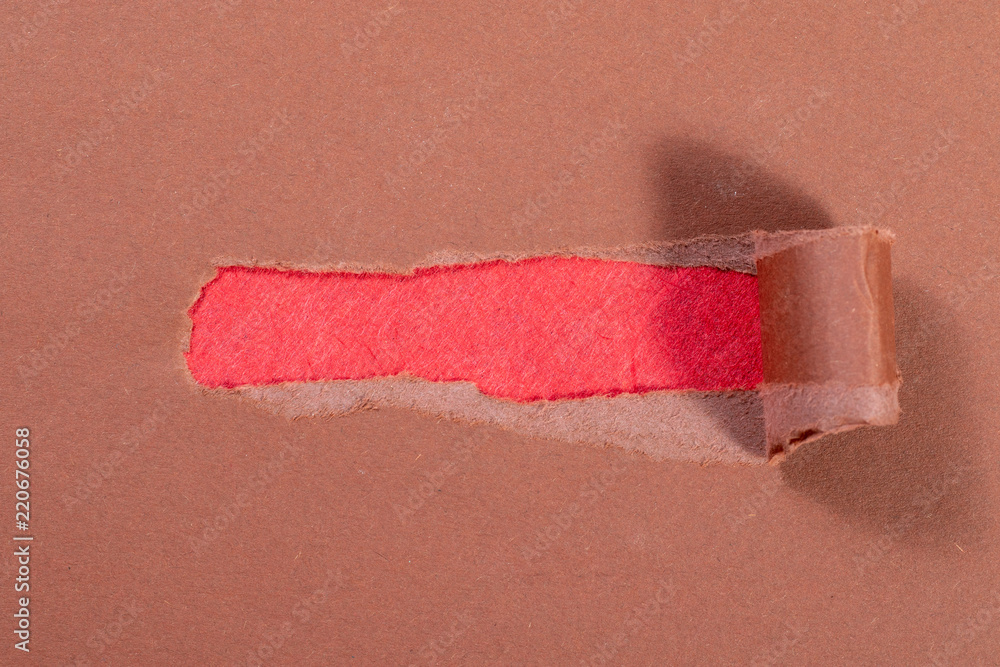Obraz premium Hole in an brown envelope with red letter