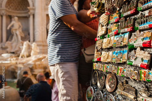 Photography Stand with a Variety of Italian Souvenirs in Rome, Italy - a shopping Couple and