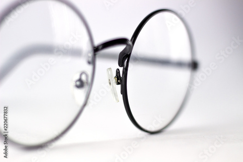 black transparent round-shaped glasses on natural white