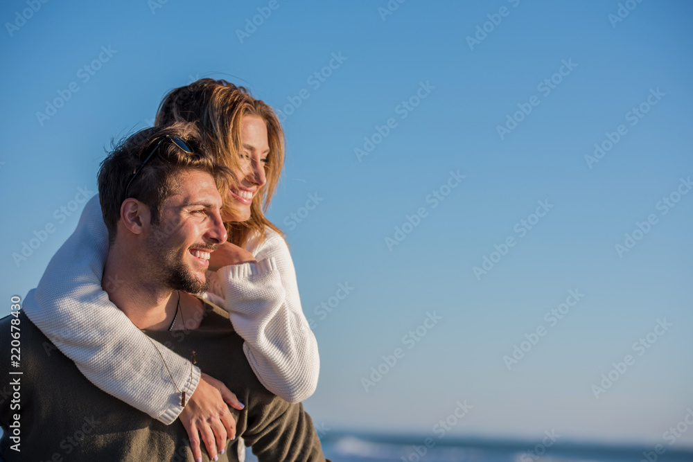 couple having fun at beach during autumn