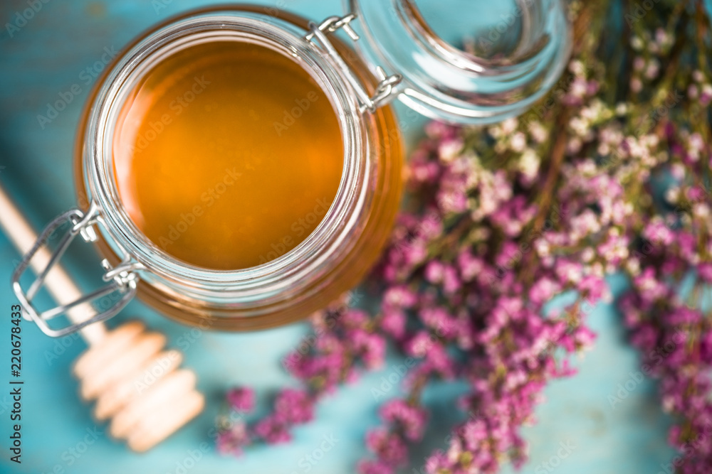 Honey jar and purple autumn heather flowers Honey jar and purple autumn heather flowers