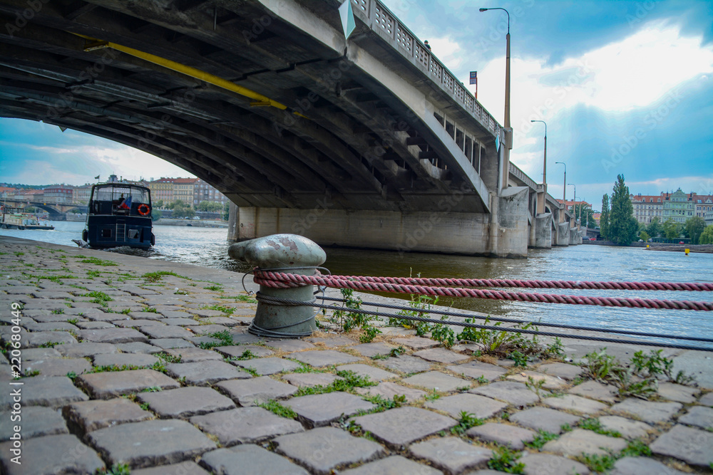 Fototapeta premium An anchored mooring line with a ship and a bridge in the background
