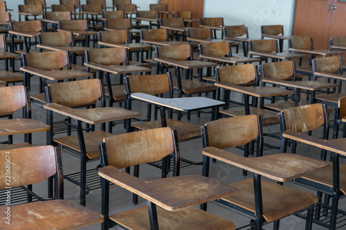 Empty classroom with vintage tone wooden chairs. Back to school concept.