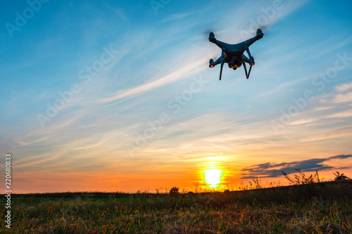 Close up on white drone camera. Drone quadcopter in flight