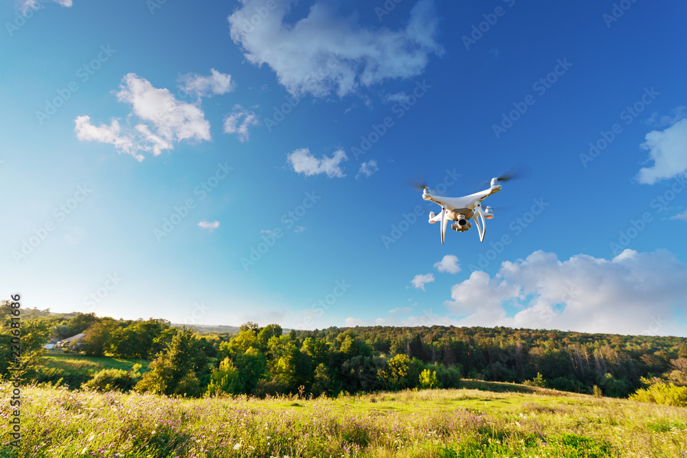 Fototapeta premium Close up on white drone camera. Drone quadcopter in flight
