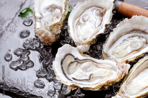 open oysters on black slate background