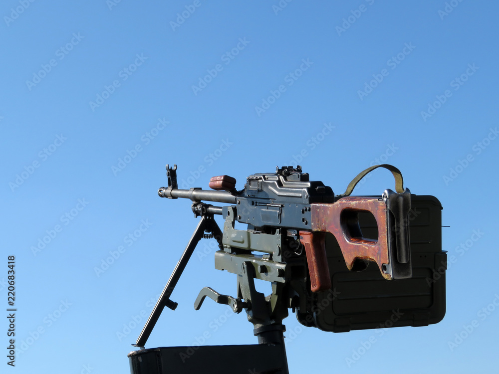 Kalashnikov machine gun mounted on the car, isolated on a clear blue sky. Russian legendary weapon, PK machinegun, caliber 7.62 mm Kalashnikov machine gun mounted on the car, isolated on a clear blue sky. Russian legendary weapon, PK machinegun, caliber 7.62 mm