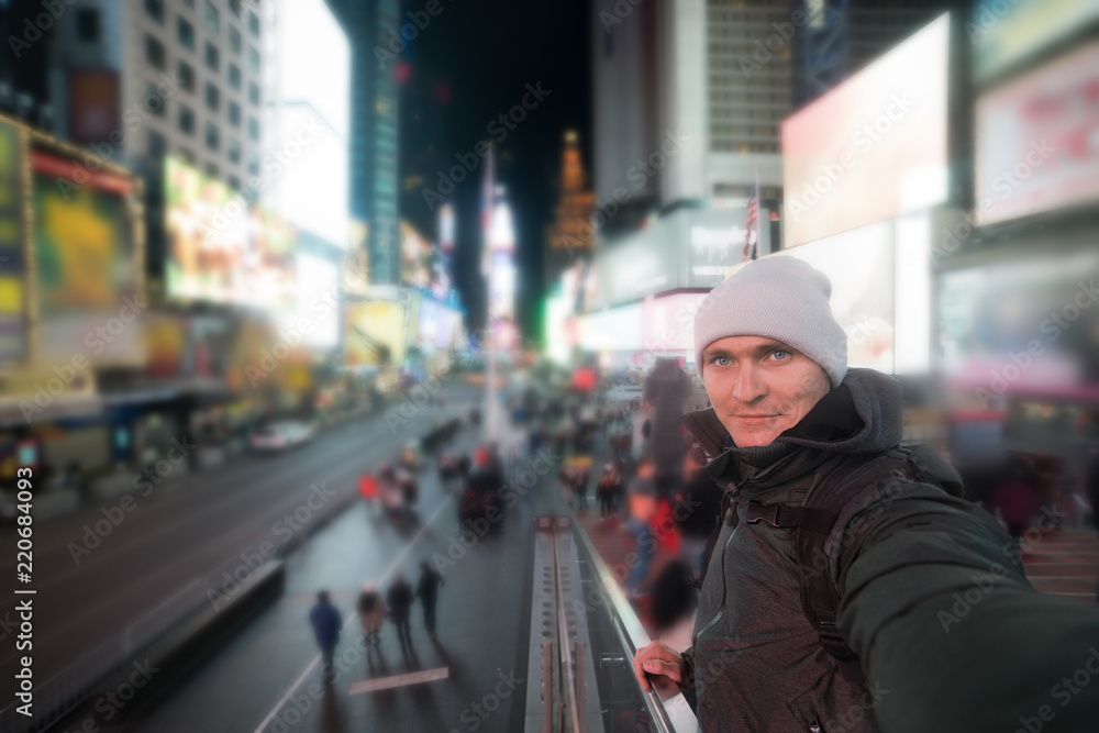 Handsome man smiling and taking selfie photo on Times Square in New York Handsome man smiling and taking selfie photo on Times Square in New York