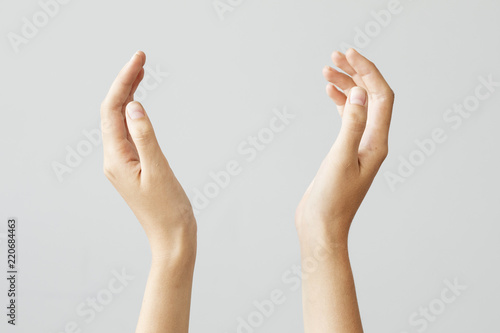 Female hand holding something on isolated background