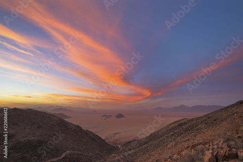 Pink colored wind swept clouds at sunset