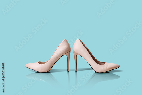 Pink, beige High heels isolated on a pastel blue background. Different colors of shoes, high heels arranged in a row. The concept of buying new shoes, lifestyle of a woman.