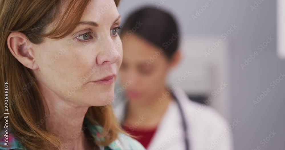 Tight shot of female patient waiting for doctor to examine her Tight shot of female patient waiting for doctor to examine her