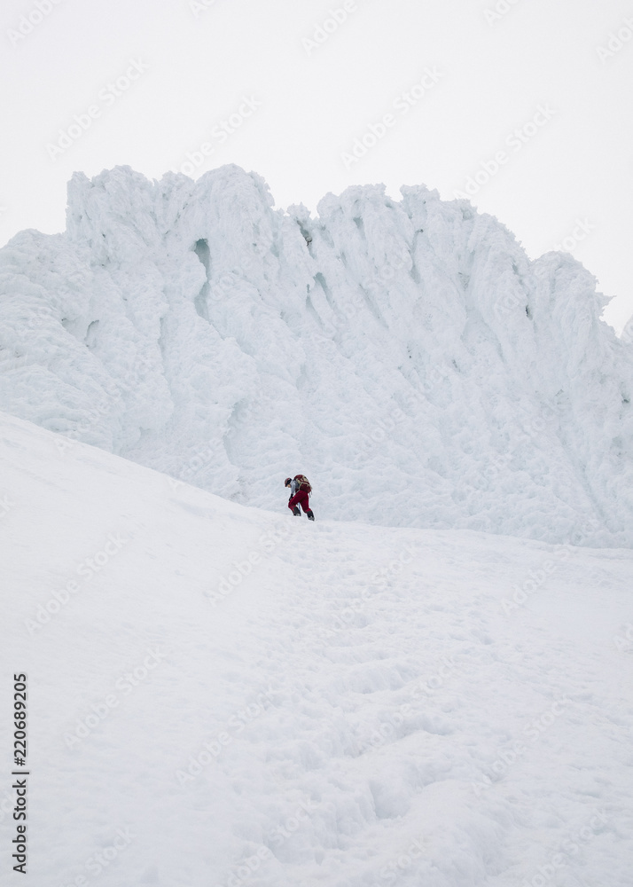 Climber pushing hard to summit the frozen mountain